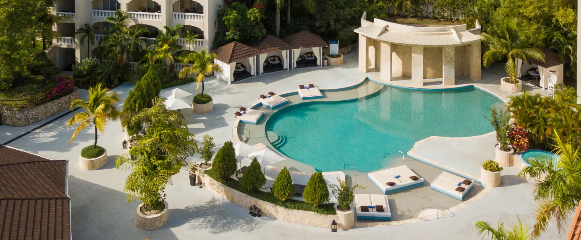 Tropical poolside oasis with loungers