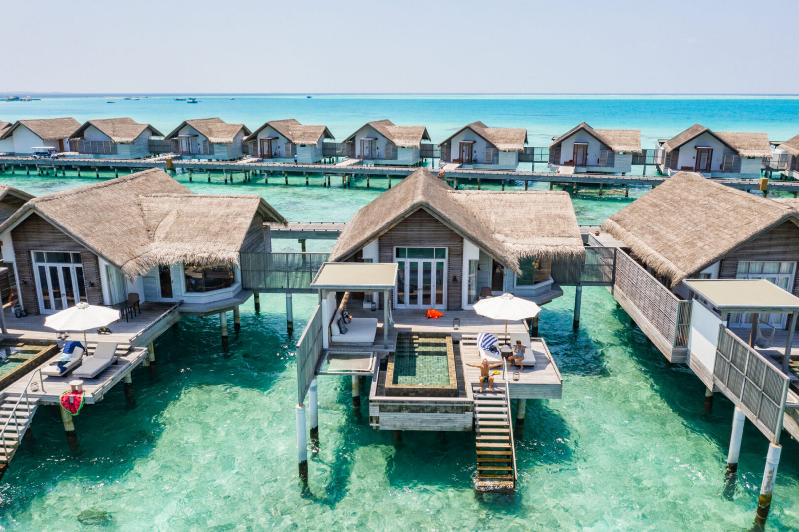 Overwater bungalows on turquoise sea