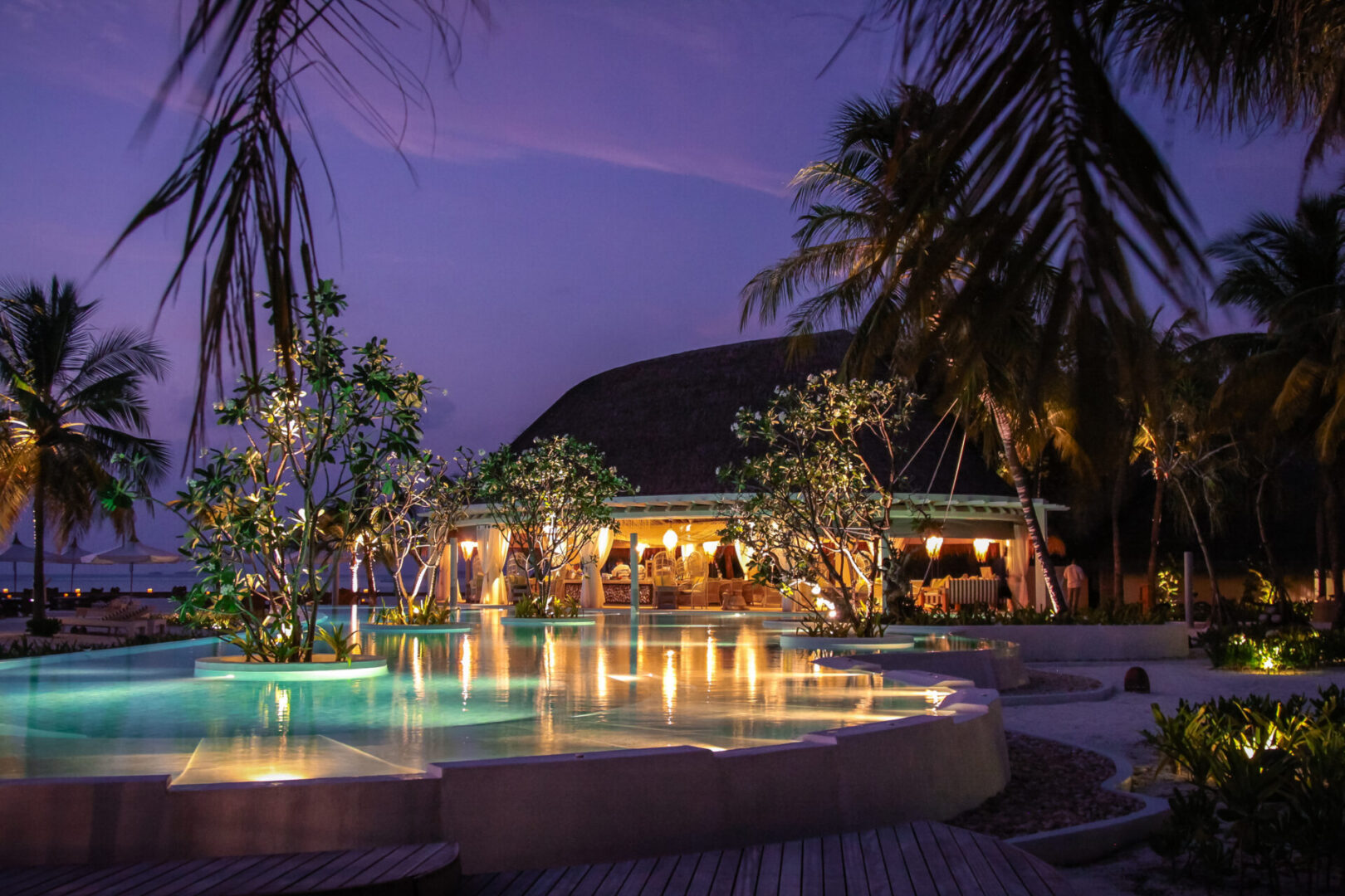 Luxury resort with palm trees at dusk