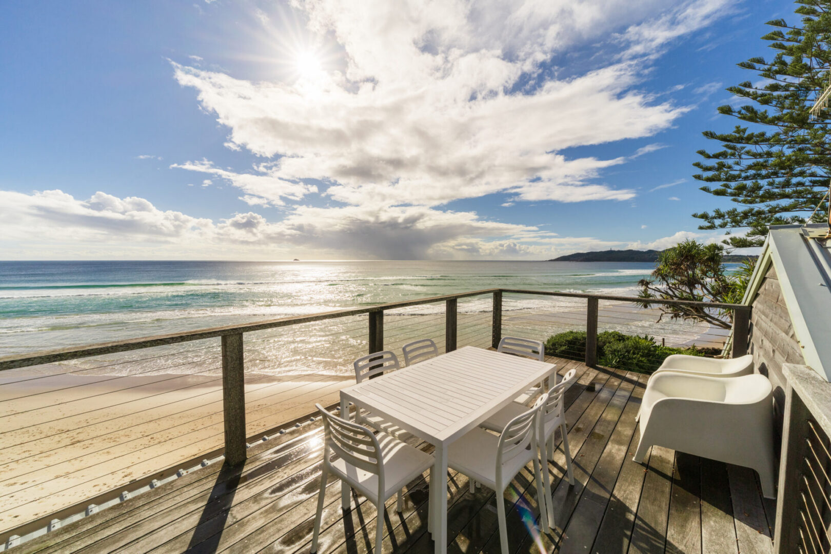 Sunny beach view from wooden deck