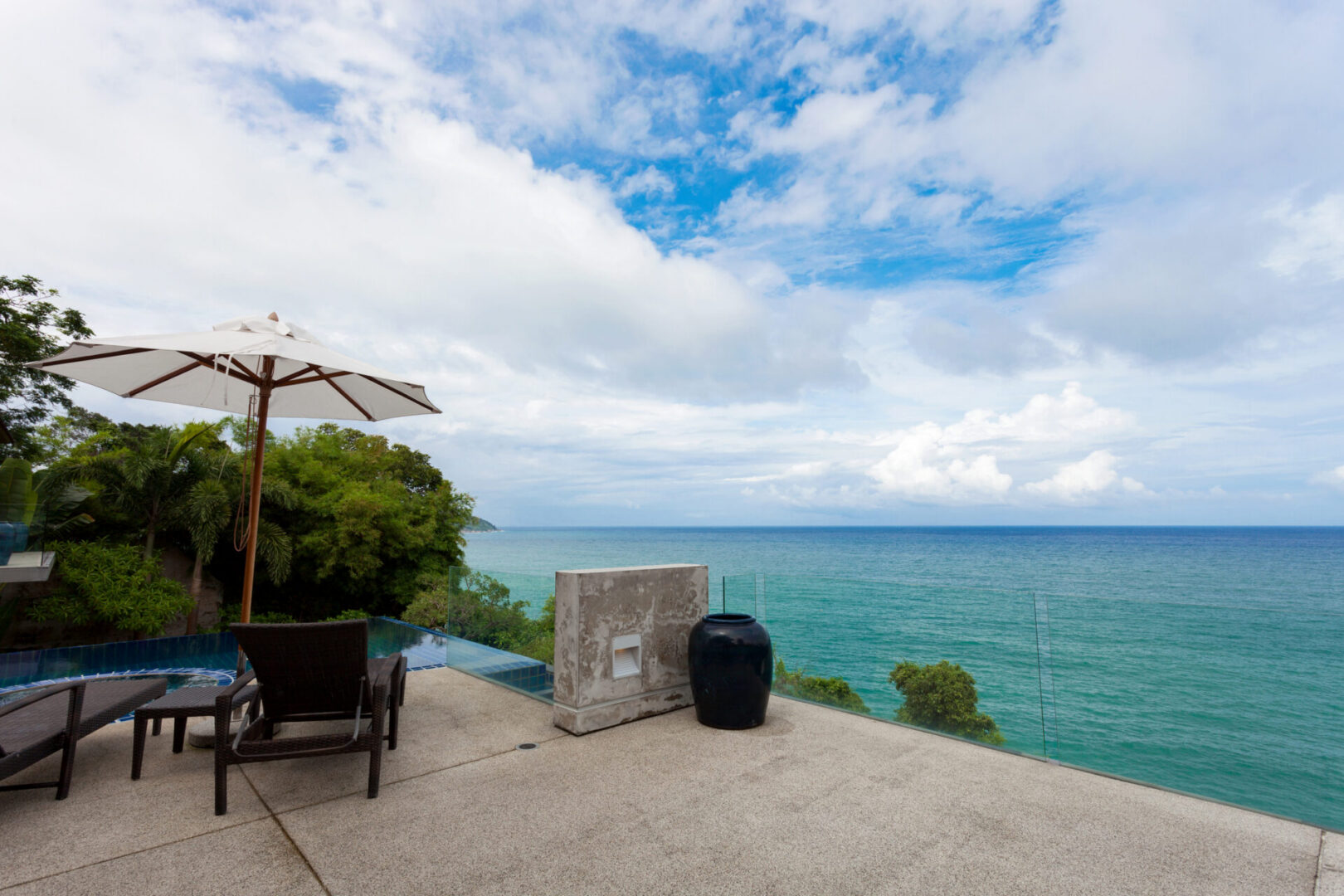 Oceanfront patio with umbrella and chairs