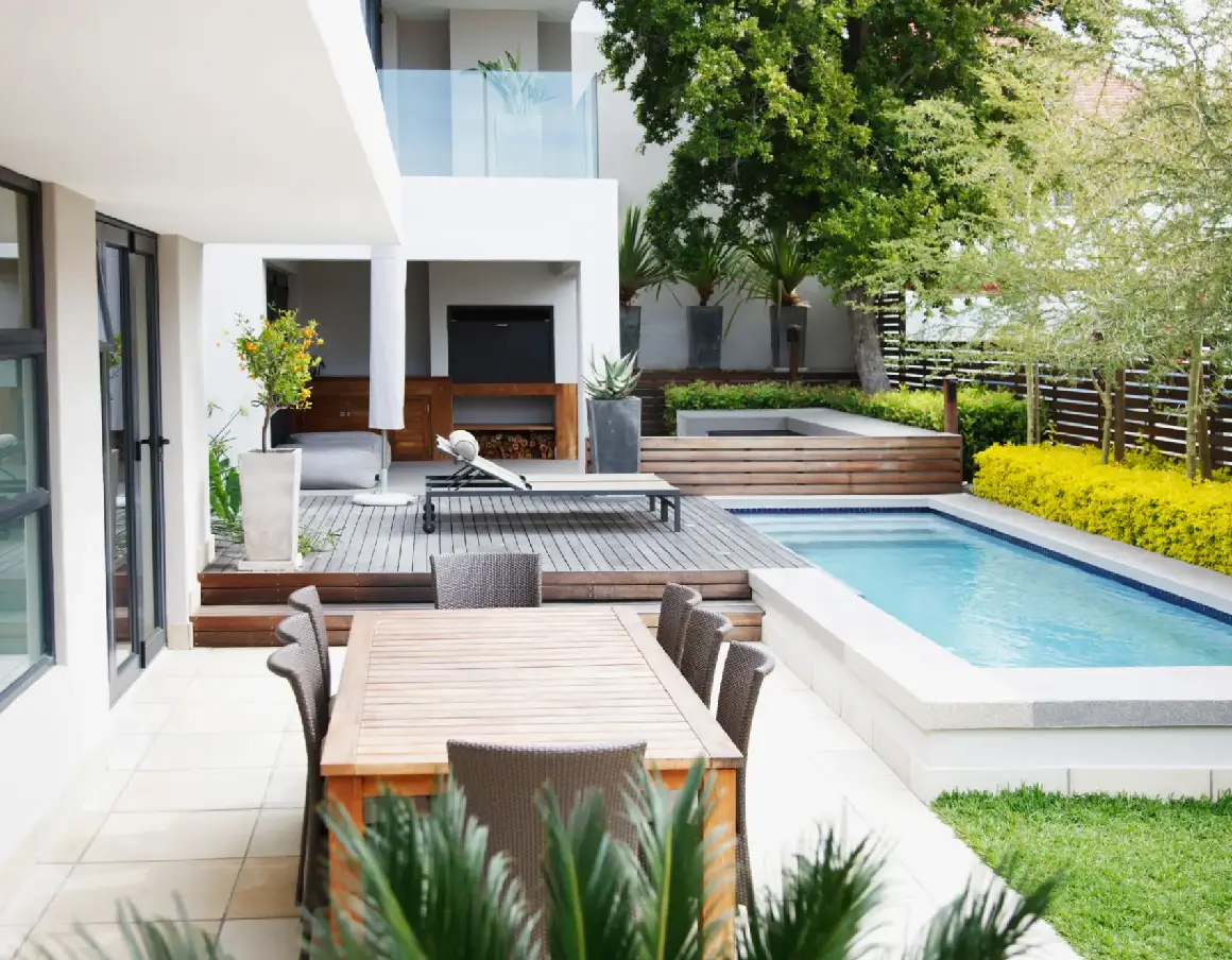 Modern backyard with pool and dining area.
