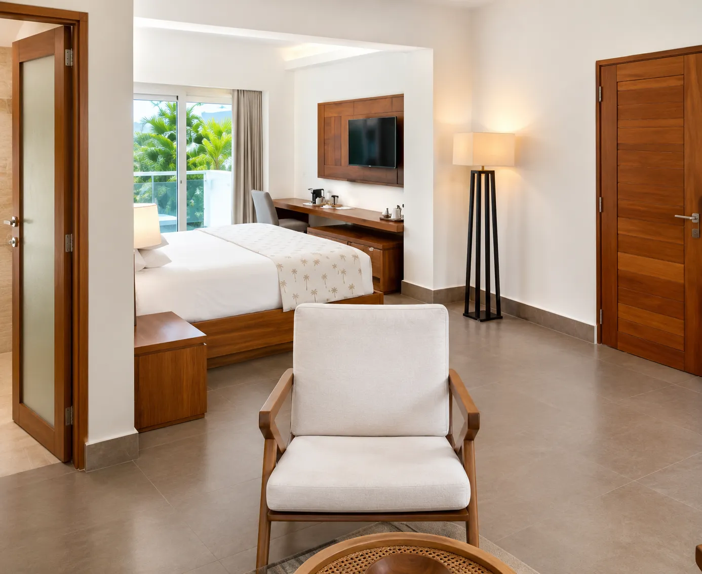 Modern hotel room with bed and chair.
